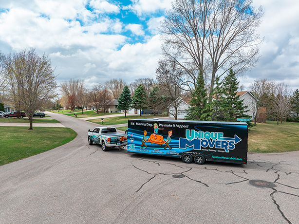 TruckTrailer Unique Movers truck and trailer assisting on a residential move