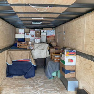 A half-full home moving trailer packed half-full by the Unique Movers team.