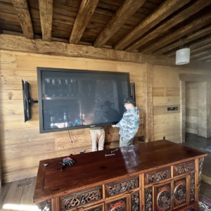 The Unique Movers team helps move a television.