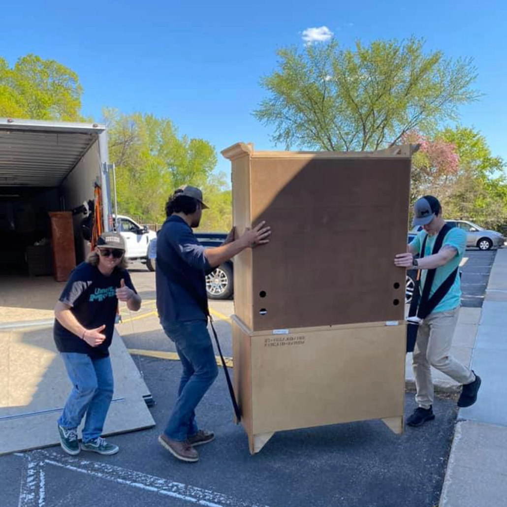 The Unique Movers team helps dispose of some furniture.