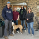 Couple with dog poses for a photo with Unique Movers home movers.