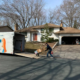 A mover using a utility dolly to load boxes into a trailer.