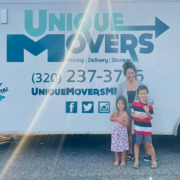 A smiling family that just got done moving.