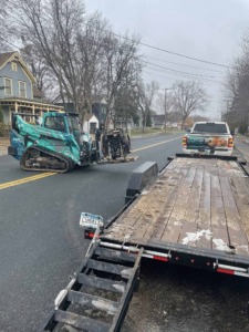 Unique Movers skid loader moving large debris