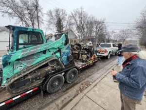 Unique Movers skid loader on trailer