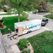 A moving trailer and truck are being loaded for a house move.