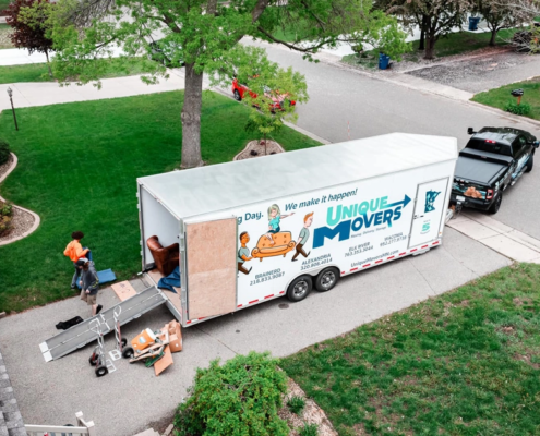 movingInsurance-socialImageTemplate A moving trailer and truck are being loaded for a house move.