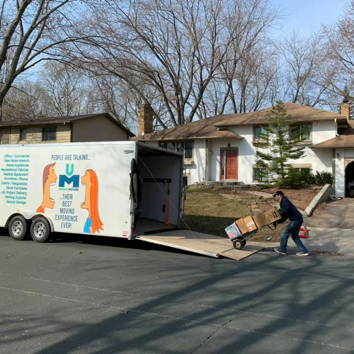 A bedroom neatly packed up with boxes for moving.