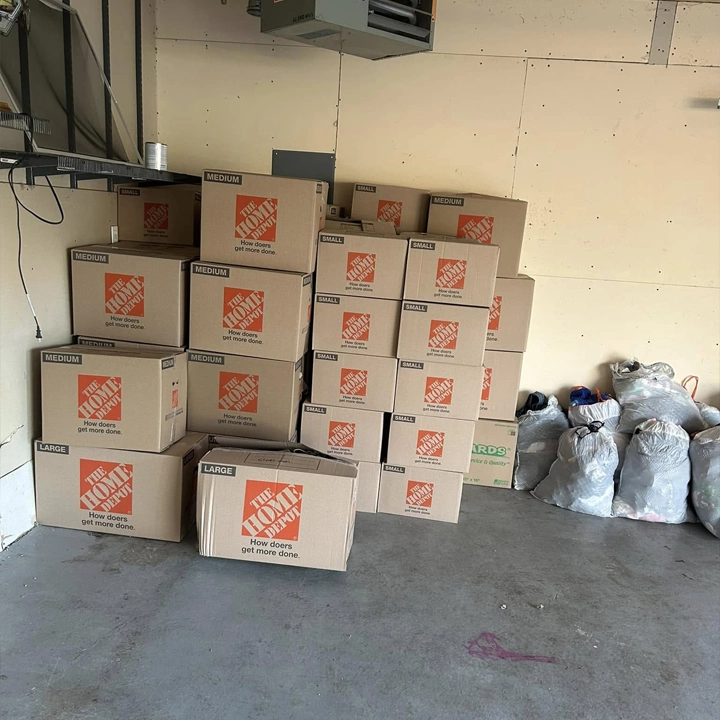 A bedroom neatly packed up with boxes for moving.
