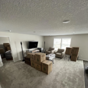 Moving boxes are packed up in a living room.