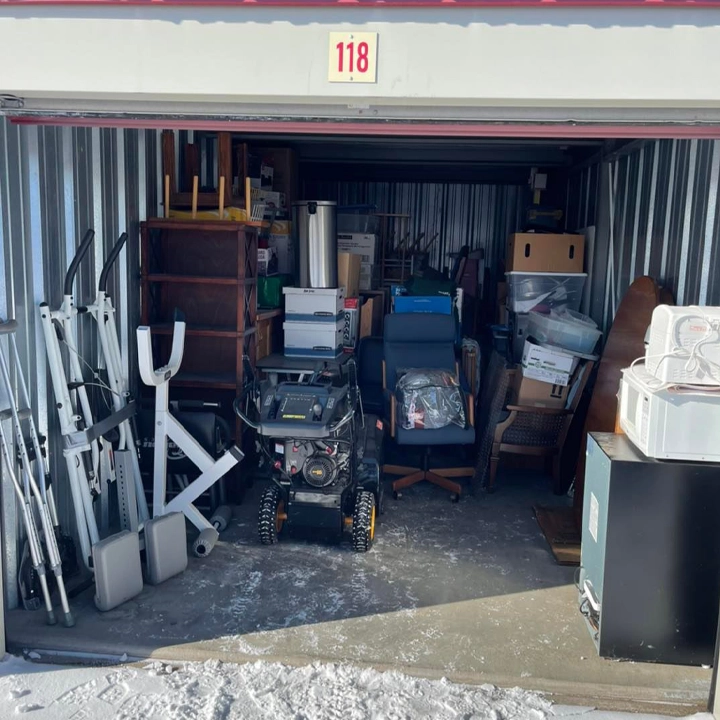 A bedroom neatly packed up with boxes for moving.