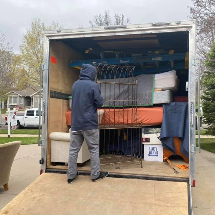 A bedroom neatly packed up with boxes for moving.