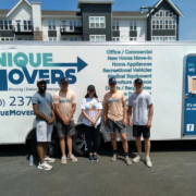 A family standing in front of a moving trailer.