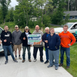 Happy customers pose with their Unique Movers moving team.
