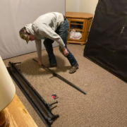 A professional mover disassembling a bed frame before a move.