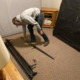 A professional mover disassembling a bed frame before a move.